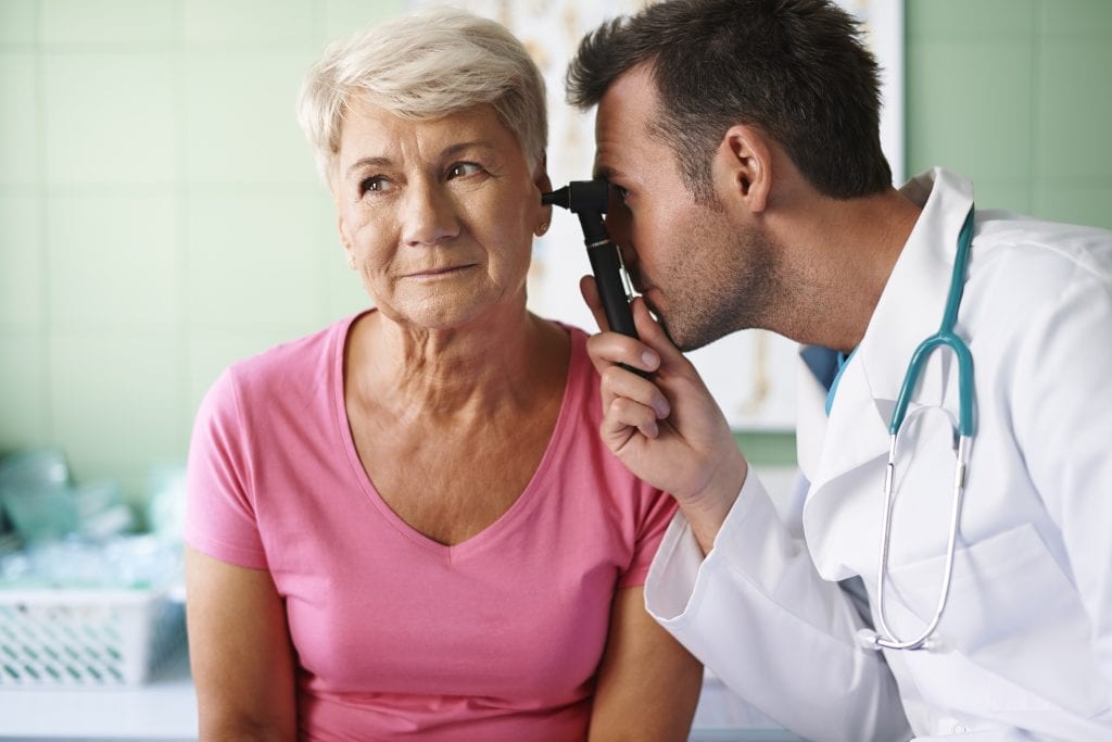 storyblocks doctor examining ear of senior woman HbZrlCDcf